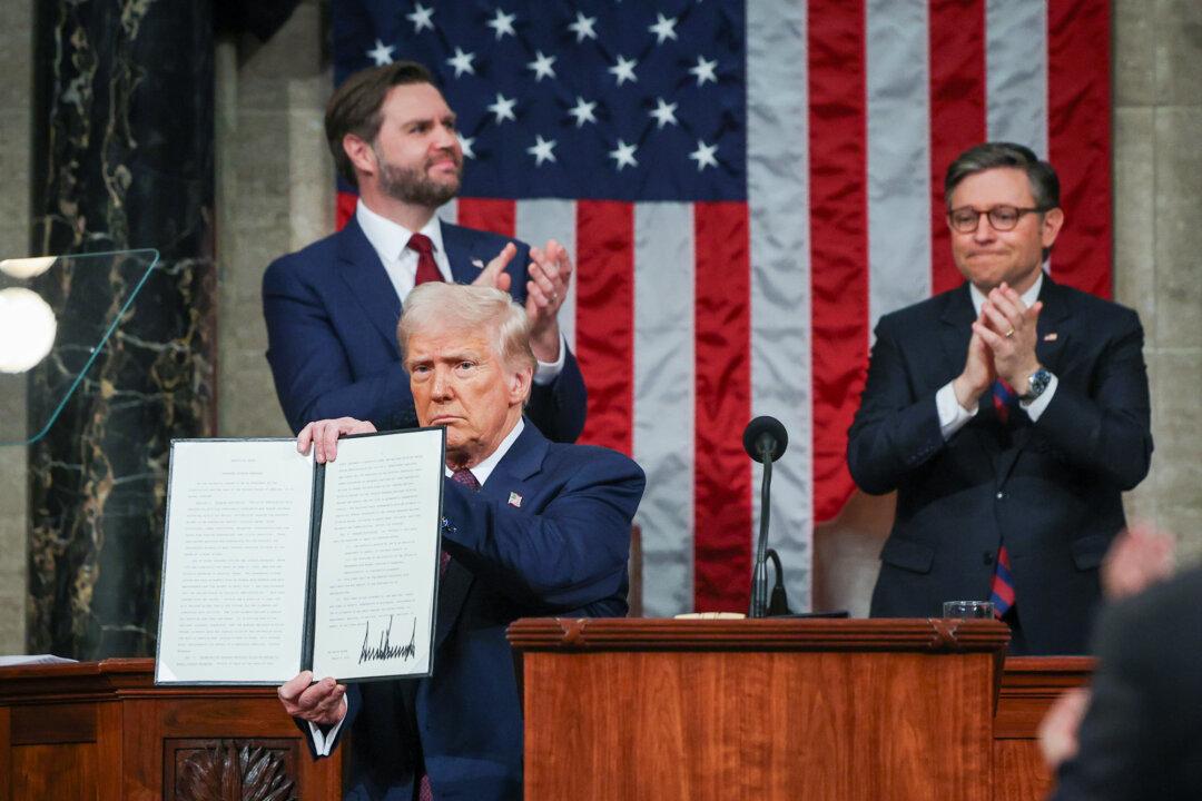President Donald Trump holds a copy of an executive order honoring Jocelyn Nungaray, a 12-year-old girl who was killed by illegal immigrants, as he addresses a joint session of Congress at the U.S. Capitol on March 4, 2025. (Win McNamee/Getty Images)