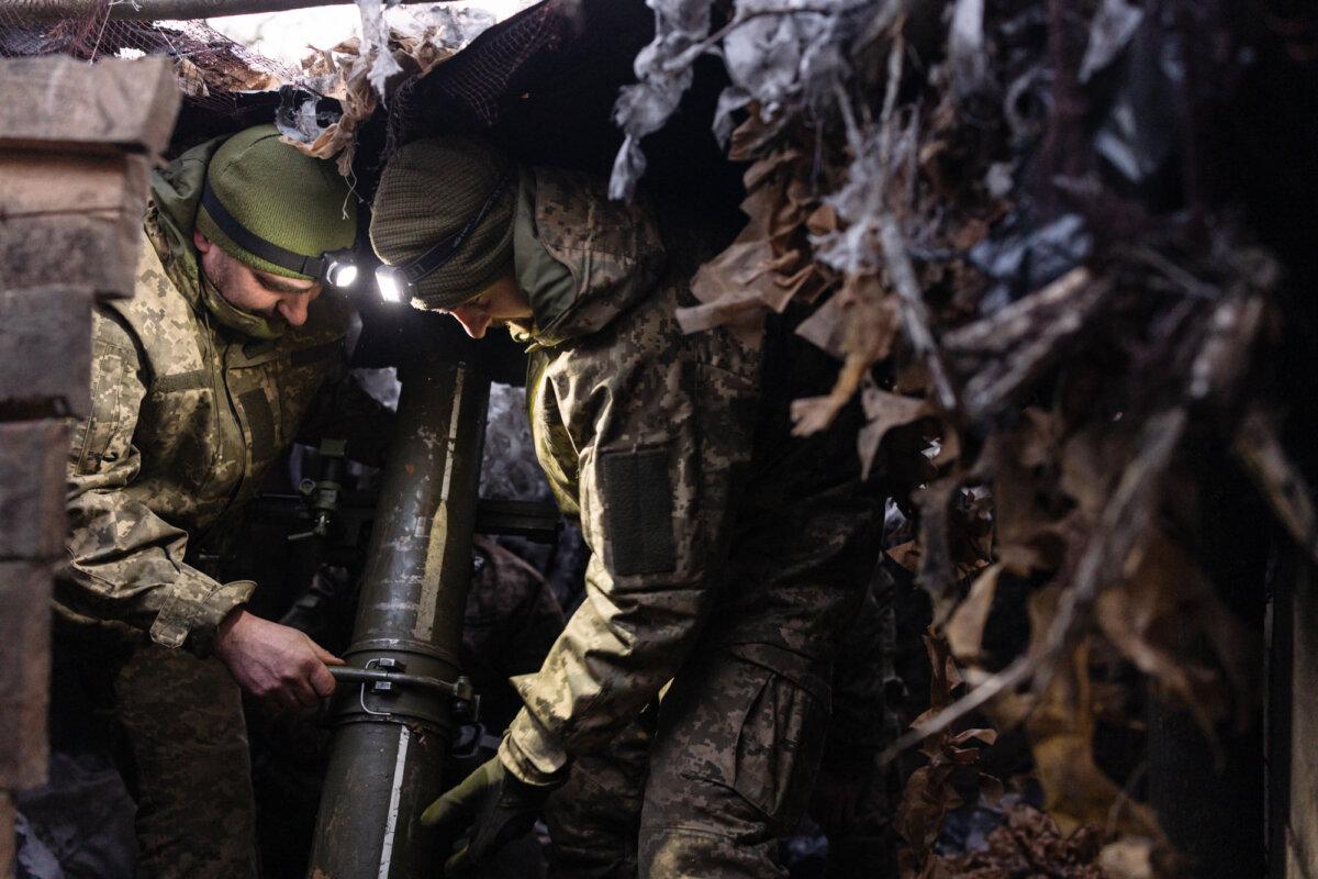 Ukrainian soldiers aim a mortar toward Russian positions in the Sumy region, Ukraine, on March 9, 2025. (Diego Fedele/Getty Images)