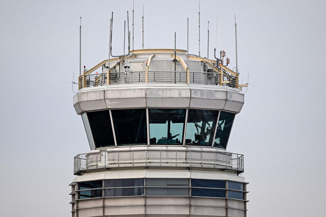 A man gestures inside the control tower of Reagan National Airport on the day after an American Airlines flight crashed into the river after colliding with a U.S. Army helicopter near Washington on Jan. 30, 2025. The FAA is increasing efforts to improve clarity of radio communications and also has launched an analysis of “close encounters between pilots flying visually and pilots flying under air traffic control.” (Oliver Contreras/AFP via Getty Images)