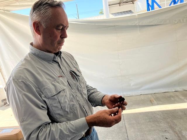 Martin Ellis, Green Carbon Solutions founder and president, examines biochar, or “engineered charcoal,” that his plant in Indiantown, Fla., produces from eucalyptus wood for U.S.-based silicon chip manufacturers, an effort he said will “make the supply chain more sustainable” for domestic industries. (John Haughey/The Epoch Times)