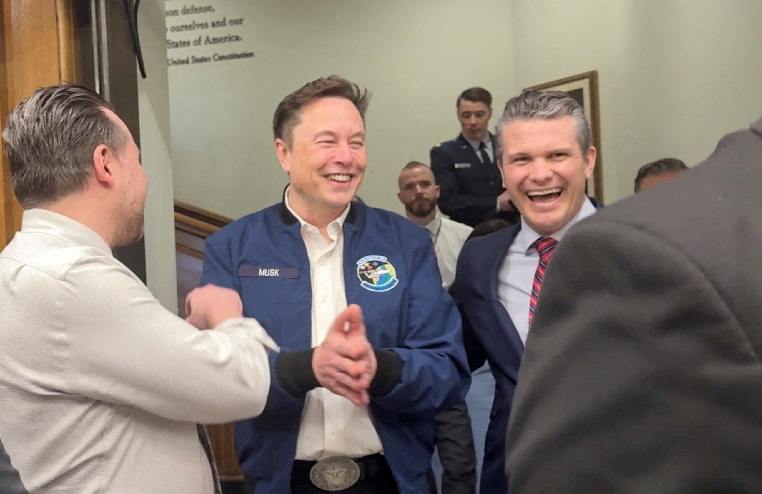 Elon Musk and U.S. Defence Secretary Pete Hegseth laugh at the Pentagon in Washington on March 21, 2025, in this screengrab obtained from a video. (Idrees Ali/Reuters)