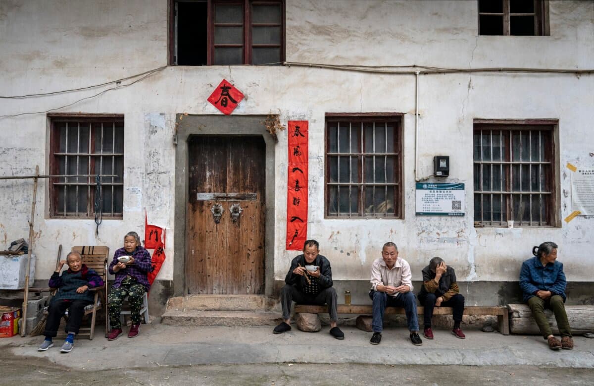 Villagers eat together outside a local house in a farming community in She County, Anhui Province, China, on May 12, 2023. (Kevin Frayer/Getty Images)