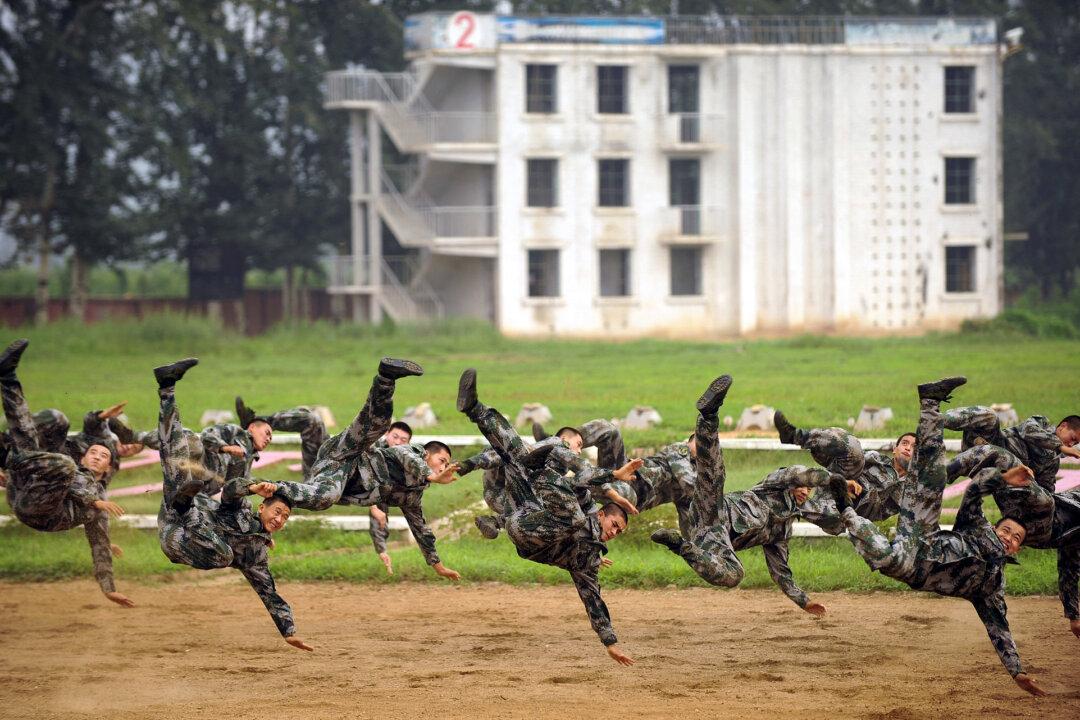 Chinese People's Liberation Army soldiers show off their fighting skills at a media event on the outskirts of Beijing on July 28, 2009. (Peter Parks/AFP via Getty Images)