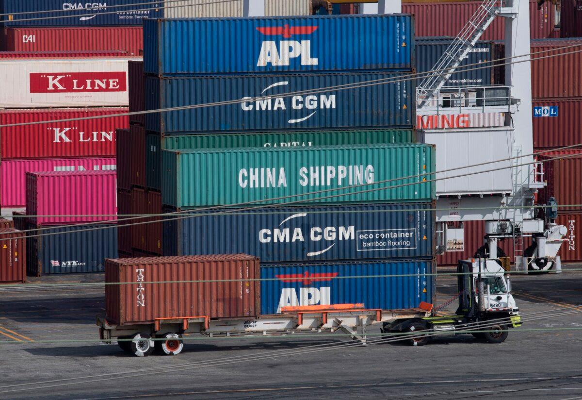 A truck passes by containers at the Port of Los Angeles, after new tariffs on Chinese imports were imposed, in Long Beach, Calif., on Sept. 1, 2019. (Mark Ralston/AFP via Getty Images)
