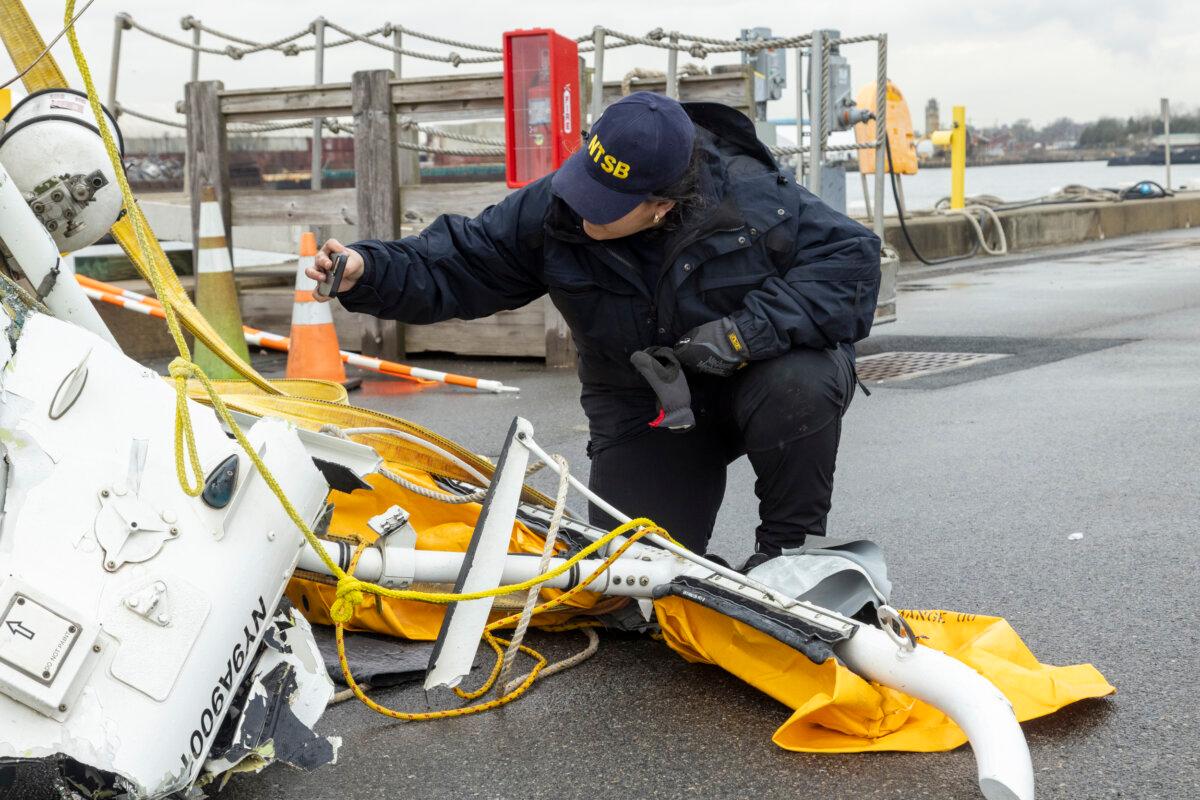 A National Transportation Safety Board team member surveys the wreckage recovered from the Bell 206 L-4 helicopter that crashed into the Hudson River on April 10 near Jersey City, N.J., on April 10, 2025. (Courtesy of NTSB)