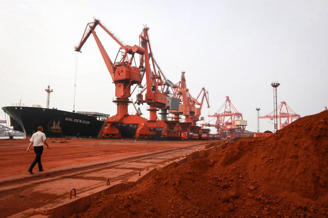 Bulldozers scoop soil containing various rare earths to be loaded onto a ship at a port in Lianyungang, Jiangsu Province, China, on Sept. 5, 2010. (STR/AFP via Getty Images)