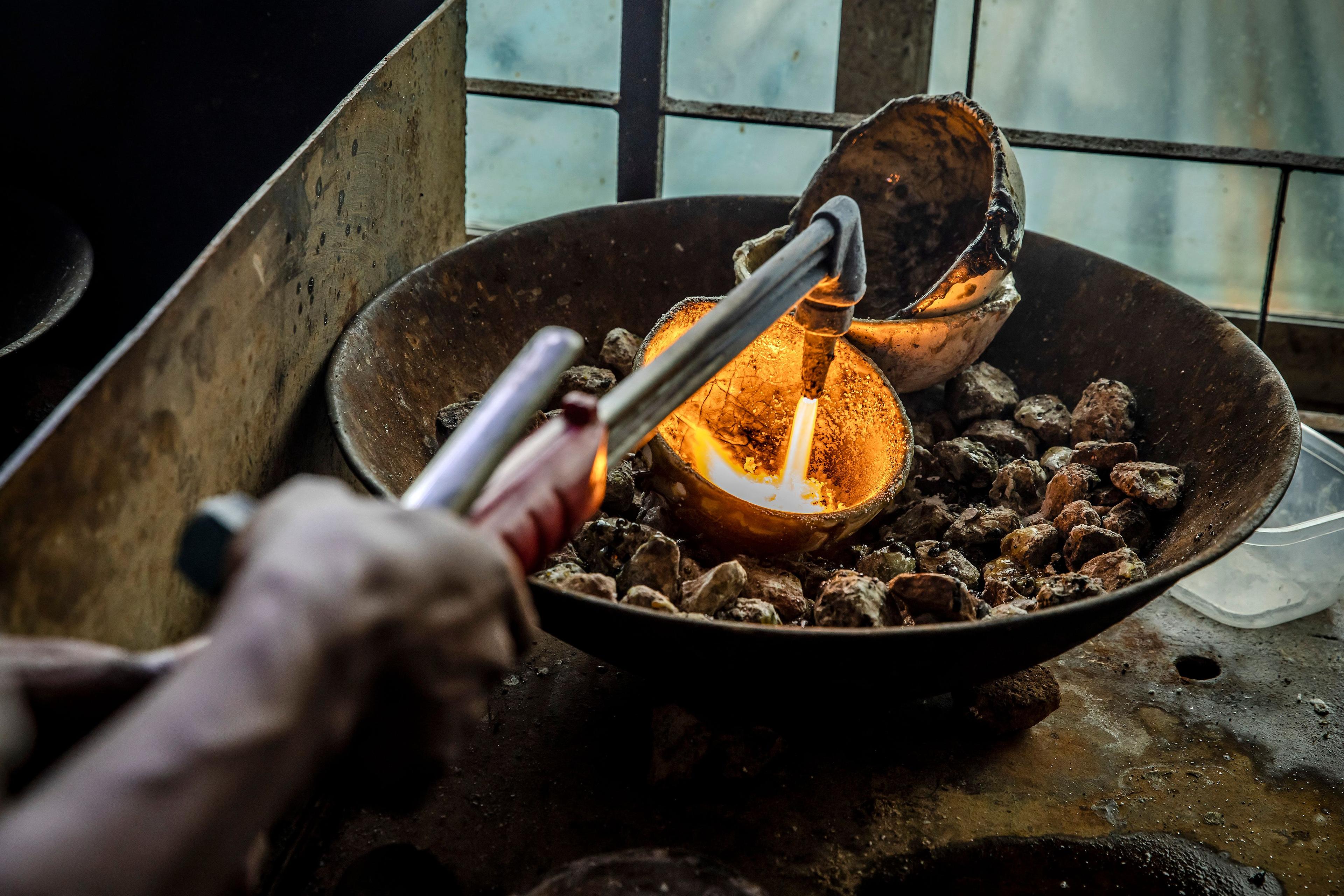 A man melts pure gold fragments coming from different mines in the region, at a gold market in Geita, Tanzania, on May 28, 2022. (Luis Tato/AFP via Getty Images)
