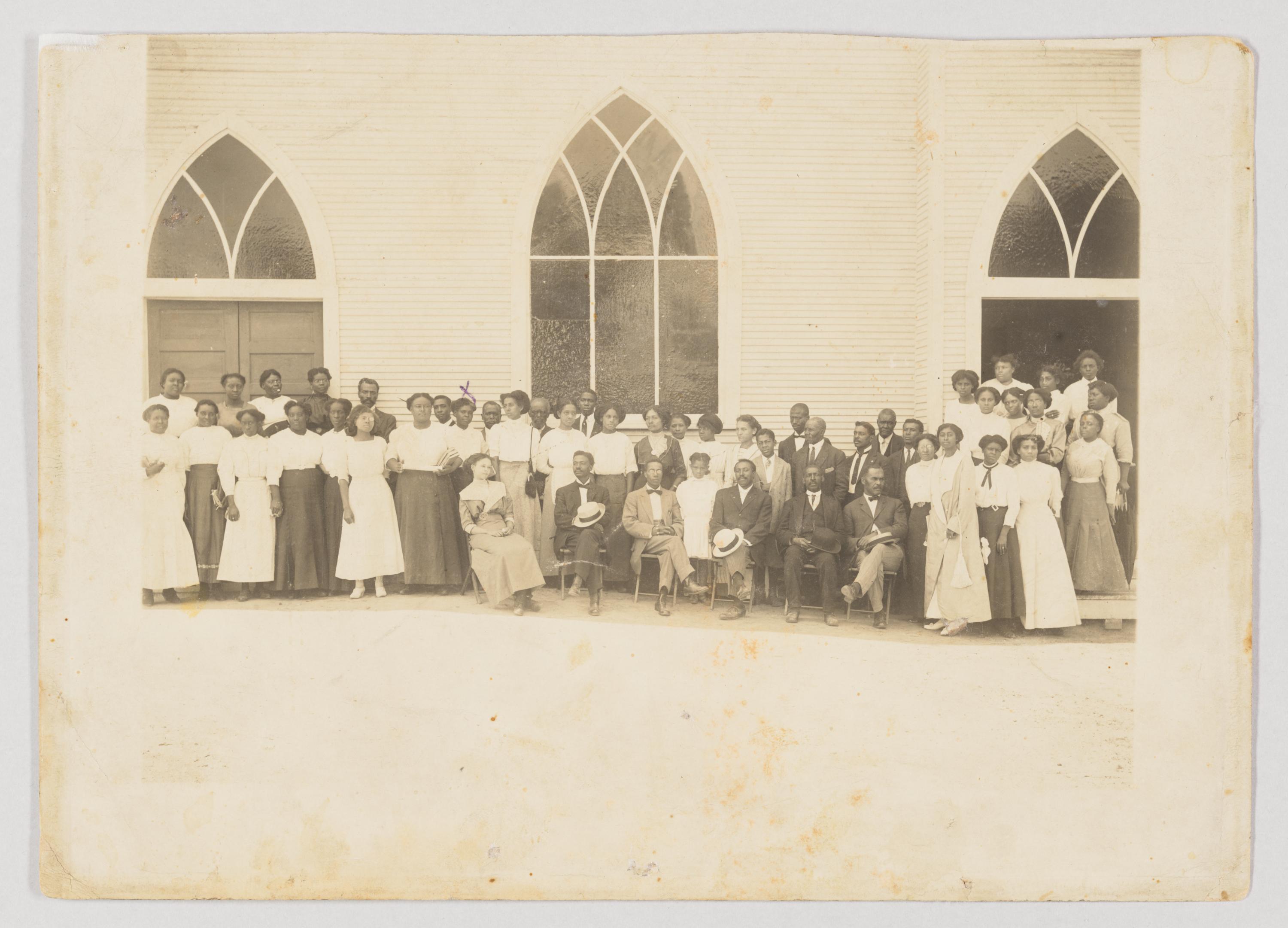 Women, men, and children stand in front of a church, possibly Vernon African Methodist Episcopal Church, in Tulsa, Okla., circa 1919. The “1776 Unites" project states that Tulsa became a famous African American entrepreneurial enclave by 1921. Collection of the Smithsonian National Museum of African American History and Culture. (Public Domain)