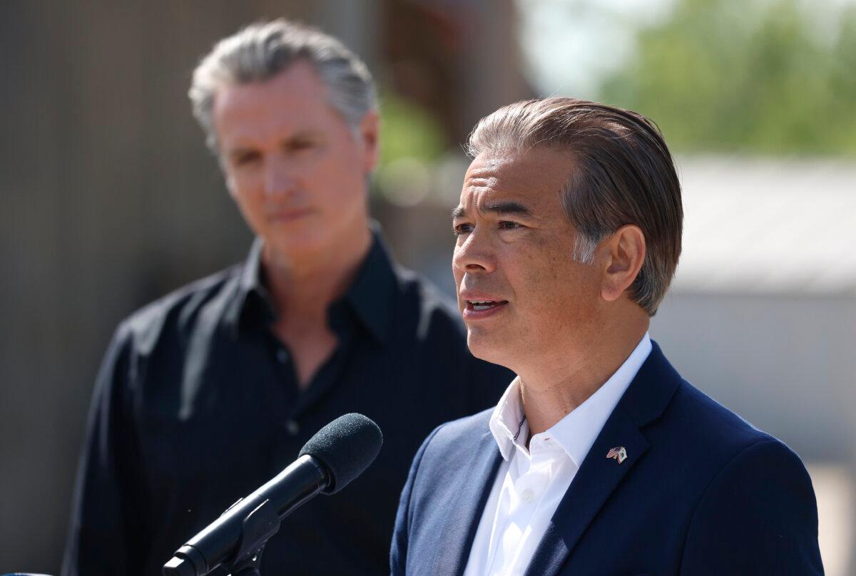 Attorney General Rob Bonta speaks as Gov. Gavin Newsom looks on during a news conference at Gemperle Orchard in Ceres, Calif., on April 16, 2025. (Justin Sullivan/Getty Images)
