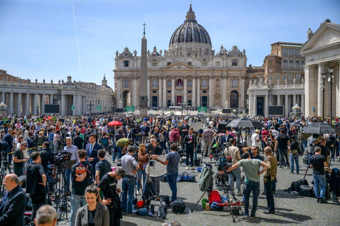 Journalists and media gather at St. Peter's Square following the death of Pope Francis in Rome on April 21, 2025. The Vatican announced that the pontiff, 88, died at 7:35 a.m. local time. He appeared in St Peter's Square yesterday, wishing thousands of worshippers a happy Easter. (Antonio Masiello/Getty Images)