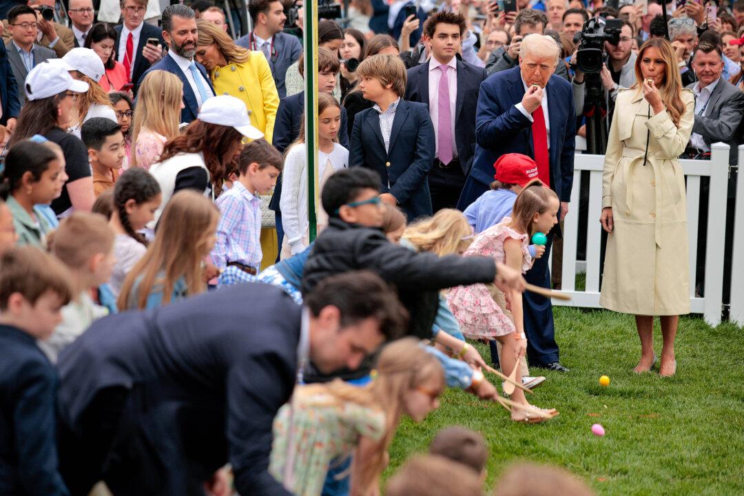 President Donald Trump and First Lady Melania Trump blow whistles to start a race during the White House Egg Roll on the South Lawn in Washington on April 21, 2025. The White House is expecting thousands of children and adults to participate in the annual tradition of rolling colored eggs down the White House lawn, a tradition started by President Rutherford B. Hayes in 1878. (Chip Somodevilla/Getty Images)