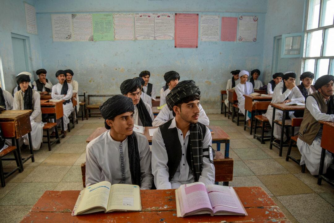 Afghan school boys wearing salwar kameez and turbans as part of a new uniform code attend class at a high school in Kandahar, on April 22, 2025. It is now mandatory for male students in the country's public schools to wear the traditional Afghan attire, with some students reporting beatings if they do not comply. (Sanaullah Seiam/AFP via Getty Images)
