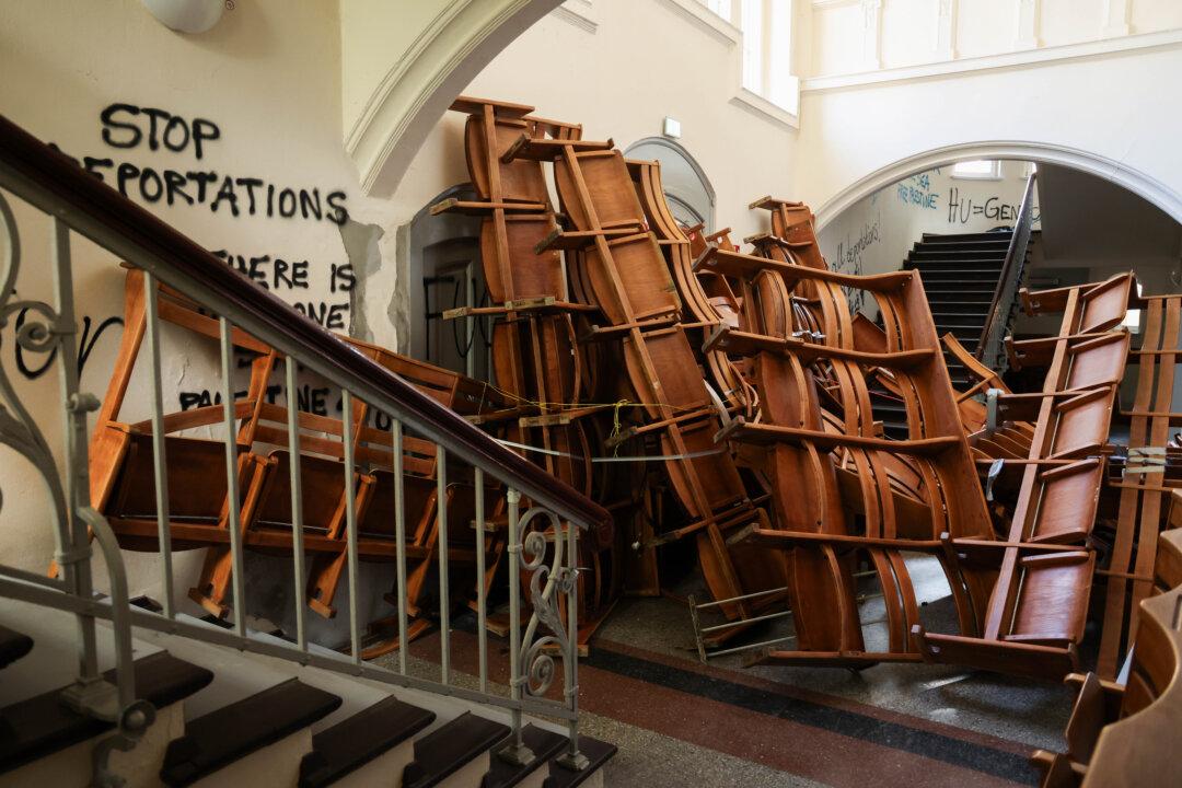 Chairs removed by pro-Palestine activists from the Emil Fischer lecture hall lie piled up as a barricade in the building's stairwell, near graffiti that covers the walls, at Berlin's Humboldt University on April 22, 2025. About 100 activists occupied the hall last week before being removed and detained by riot police. (Sean Gallup/Getty Images)