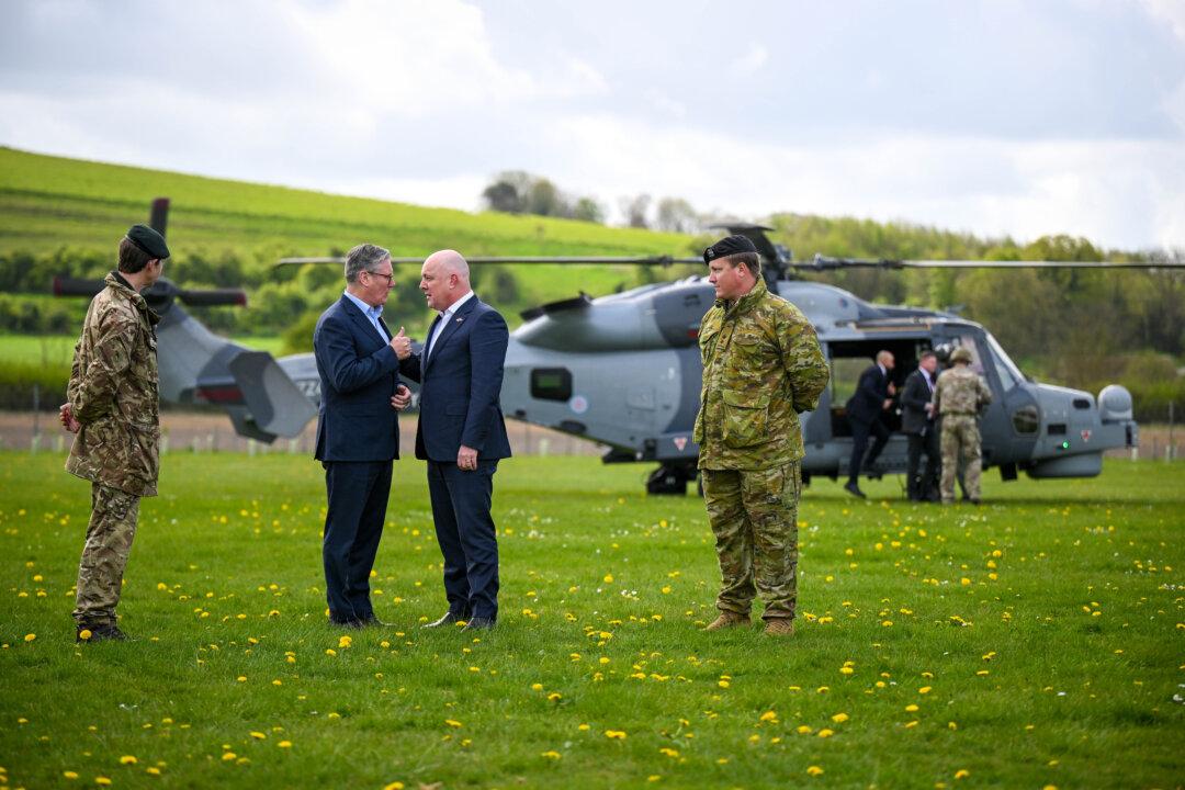 British Prime Minister Keir Starmer greets New Zealand Prime Minister Christopher Luxon during a visit to a military base training Ukrainian troops in England, on April 22, 2025. Luxon is visiting the UK and Turkey this week. (Finnbarr Webster/Getty Images)