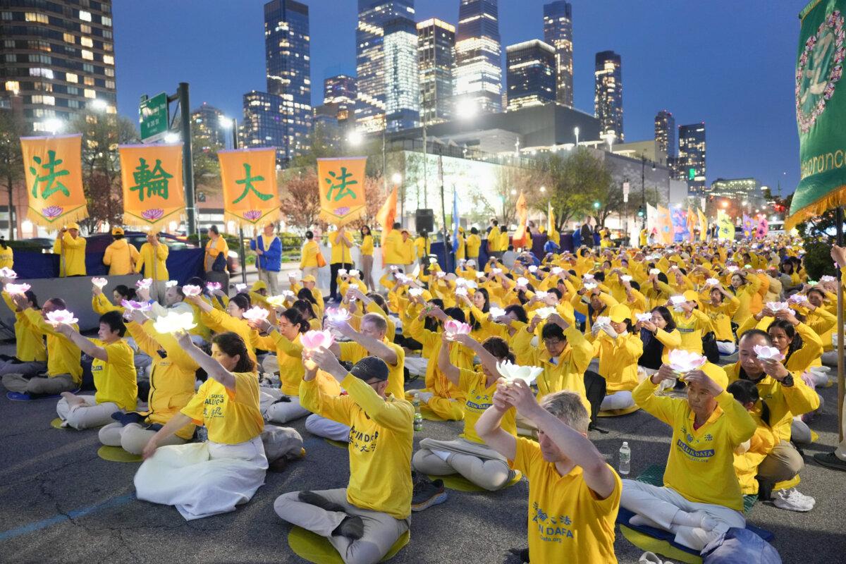 Falun Gong practitioners attend a vigil in front of the Chinese Consulate in New York on April 19, 2025. (Larry Dye/The Epoch Times)
