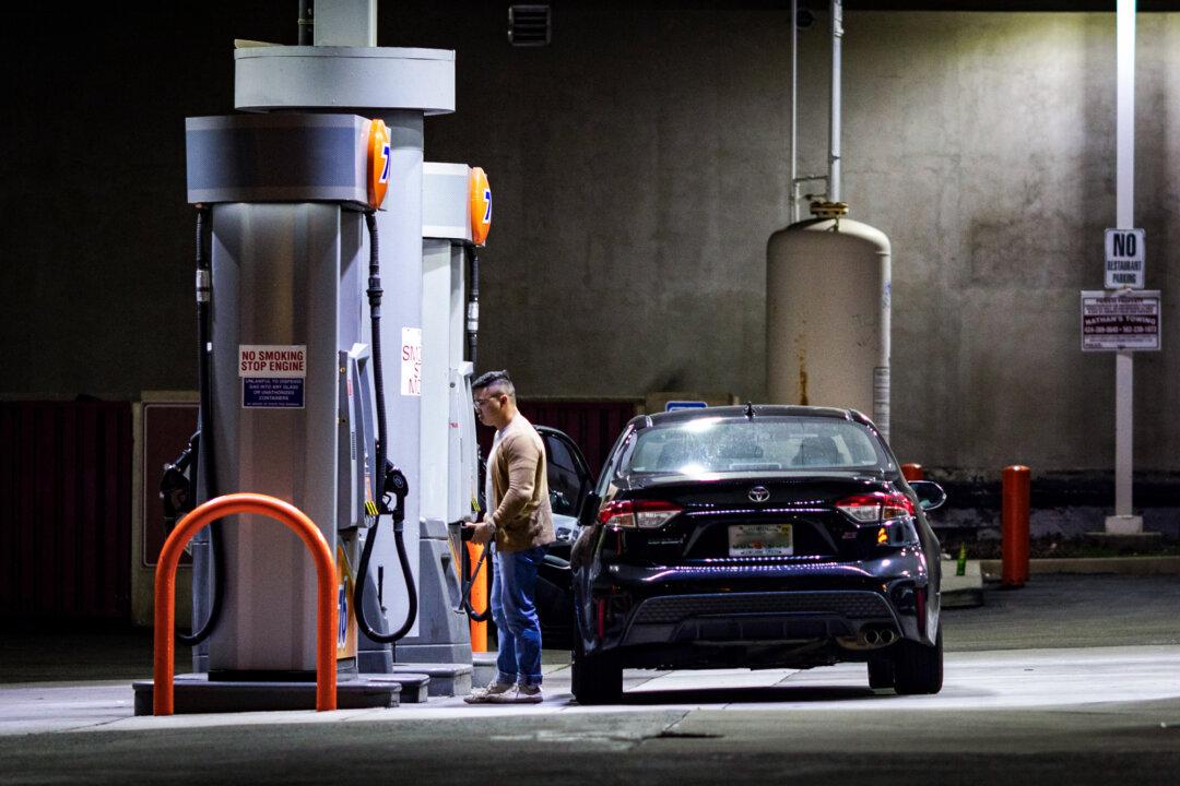 Customers fuel their vehicles at a gas station in Los Angeles on March 25, 2025. As of April 25, California gas prices were the highest in the nation at $4.79 on average—$1.60 above the national average—driven largely by state policy choices. (John Fredricks/The Epoch Times)