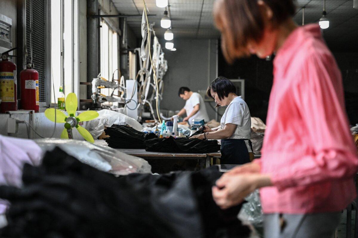 Employees produce garments at a clothing factory in Guangzhou in Guangdong Province, China, on April 16, 2025. (Jade Gao/AFP via Getty Images)