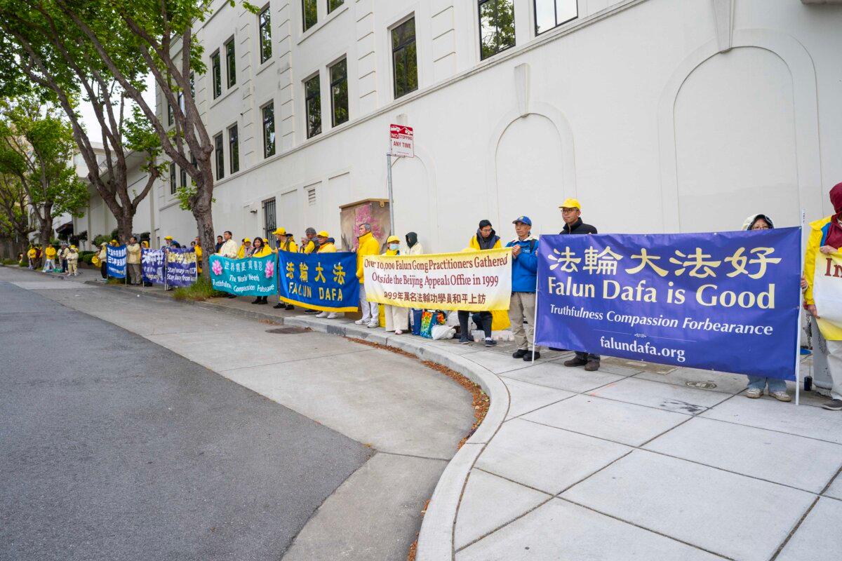 Practitioners holding banners in front of the Chinese Consulate in San Francisco on April 25, 2025. (Gary Wang/The Epoch Times)