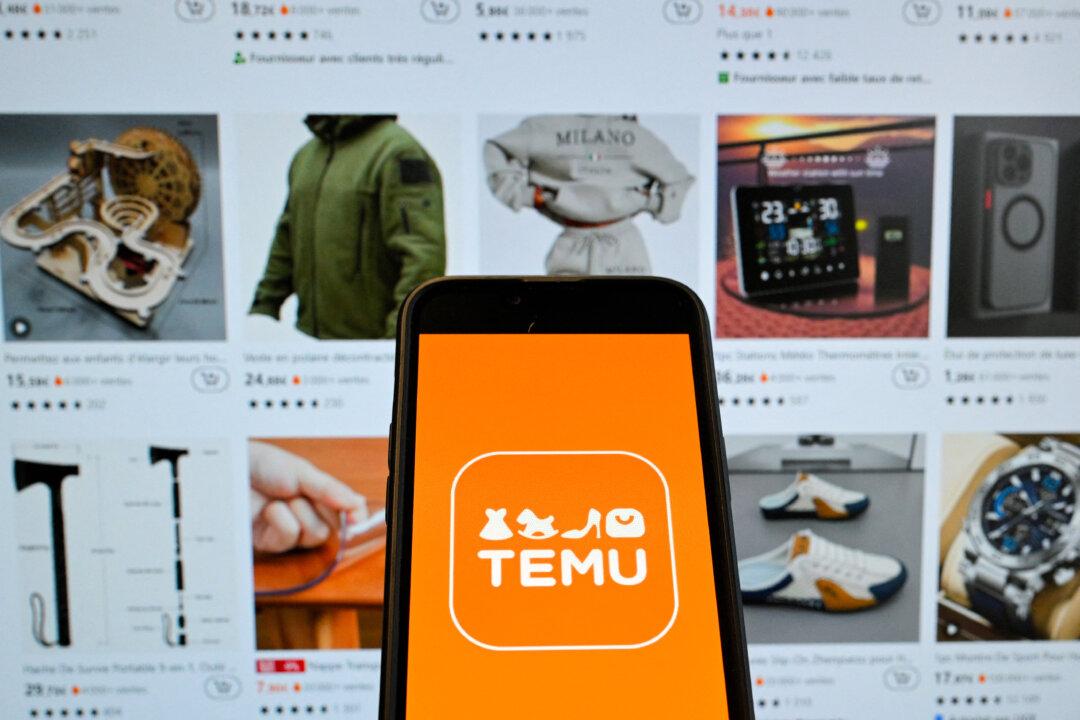 The logo of Chinese e-commerce company Temu is seen on a mobile phone in front of its website in Brussels on Nov. 4, 2024. Shein and Temu have become global e-commerce giants by selling low-cost Chinese-made goods directly to consumers. (Nicolas Tucat/AFP via Getty Images)