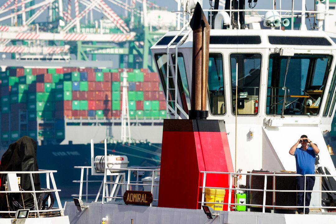 A person watches from a tugboat in San Pedro, Calif., on Nov. 30, 2021. CARB stated in 2022 that many harbor vessels still use older Tier 2 engine technology, which emits 162 times more diesel particulate matter than a 5-year-old school bus. (Mario Tama/Getty Images)