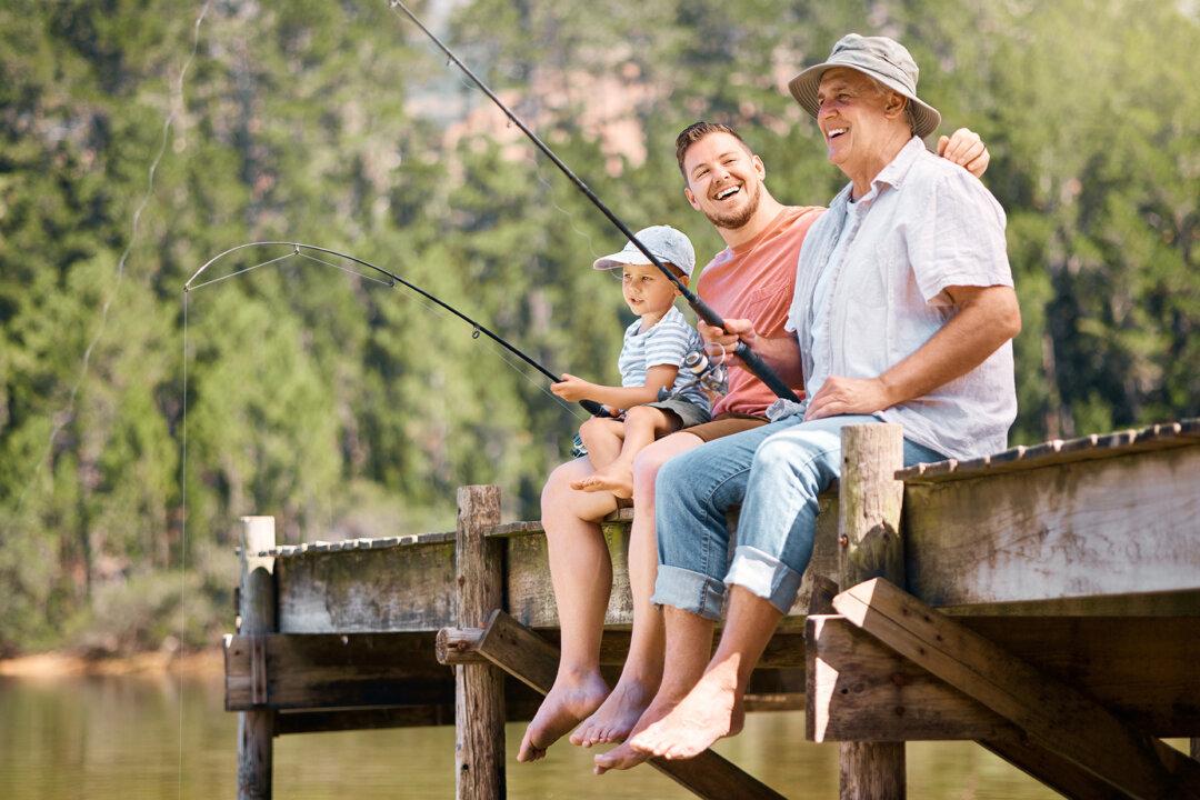 Three generations of fathers and sons spend time together. (PeopleImages.com - Yuri A/Shutterstock)