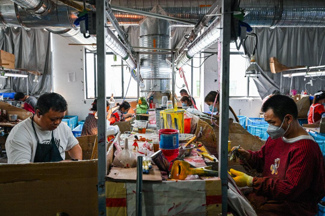 Employees work at a toy factory specializing in solar-powered plastic gadgets in Yiwu, Zhejiang Province, China, on April 11, 2025. (Adek Berry/AFP via Getty Images)