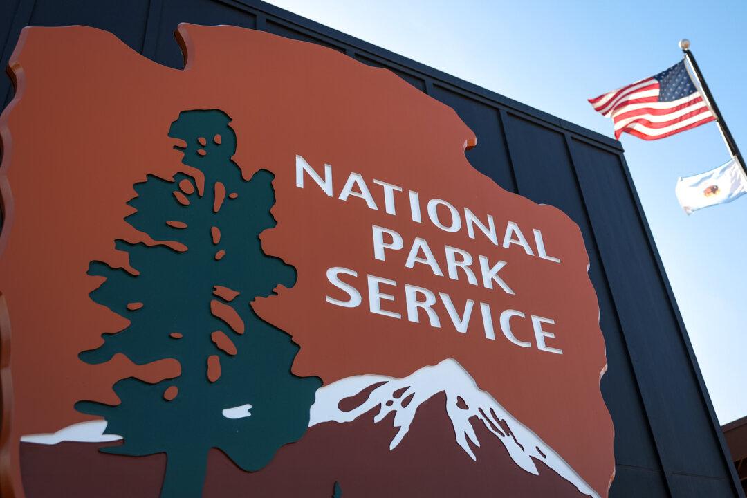 The National Park Service logo is displayed at a Joshua Tree National Park visitor center in Twentynine Palms, Calif., on Feb. 20, 2025. Both Point Reyes ranchers and environmental groups accuse the agency of bias. Ranchers argue the agency's actions violate federal law and harm the area's agricultural heritage, while groups such as the Resource Renewal Institute say the agency's plan fails to protect the environment and wildlife. (Mario Tama/Getty Images)