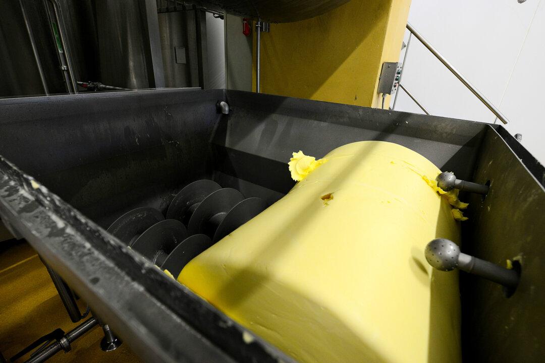 Butter is made at a factory in a biological treatment plant in Albertville, France, on April 26, 2016 (L); Butter melts on toast. (Jean-Pierre clatot/AFP via Getty Images, Scott Olson/Getty Images)