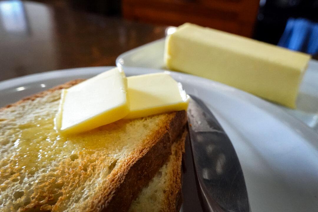 Butter is made at a factory in a biological treatment plant in Albertville, France, on April 26, 2016 (L); Butter melts on toast. (Jean-Pierre clatot/AFP via Getty Images, Scott Olson/Getty Images)