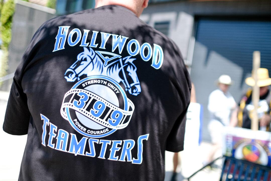 Teamsters union members join striking Writers Guild of America and Screen Actors Guild members outside Amazon Studios in Culver City, Calif., on July 19, 2023. Years of streaming wars, the COVID-19 pandemic, mergers, strikes, layoffs, and runaway production have battered the entertainment industry, leaving record job losses and dim prospects for recovery. (Chris Delmas/AFP via Getty Images)