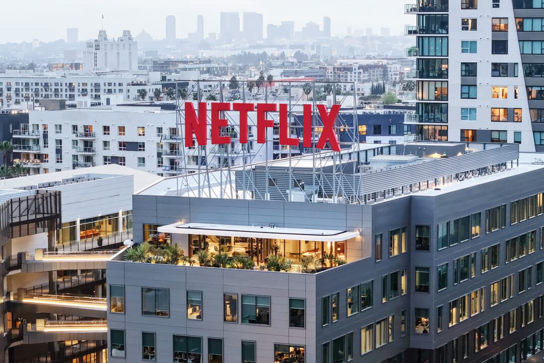 The Netflix logo is seen atop its corporate offices in Los Angeles on Jan. 24, 2024. President Donald Trump announced a 100 percent tariff on films produced abroad, but many modern productions involve multiple countries, making it difficult to determine their origin—especially for projects commissioned by platforms such as Netflix. (Mario Tama/Getty Images)
