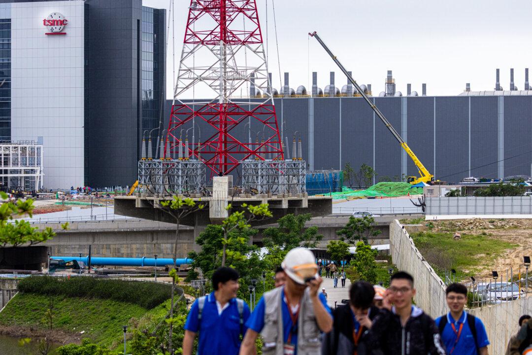 A Taiwan Semiconductor Manufacturing Co. Ltd. (TSMC) building is seen in the background at Hsinchu Science Park in Hsinchu, Taiwan, on April 18, 2025. According to data compiled by J.P. Morgan, TSMC supplies more than 90 percent of the world’s advanced AI logic chips. (Annabelle Chih/Getty Images)