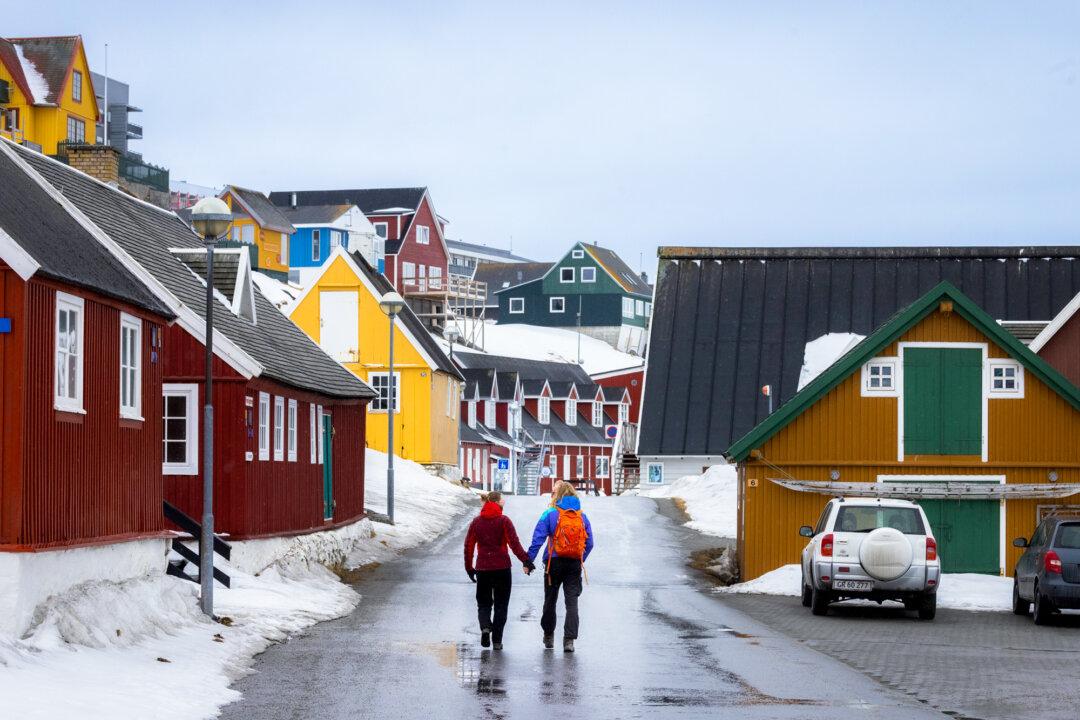 A couple walks the streets of Nuuk, Greenland, on May 3, 2025. (John Fredricks/The Epoch Times)