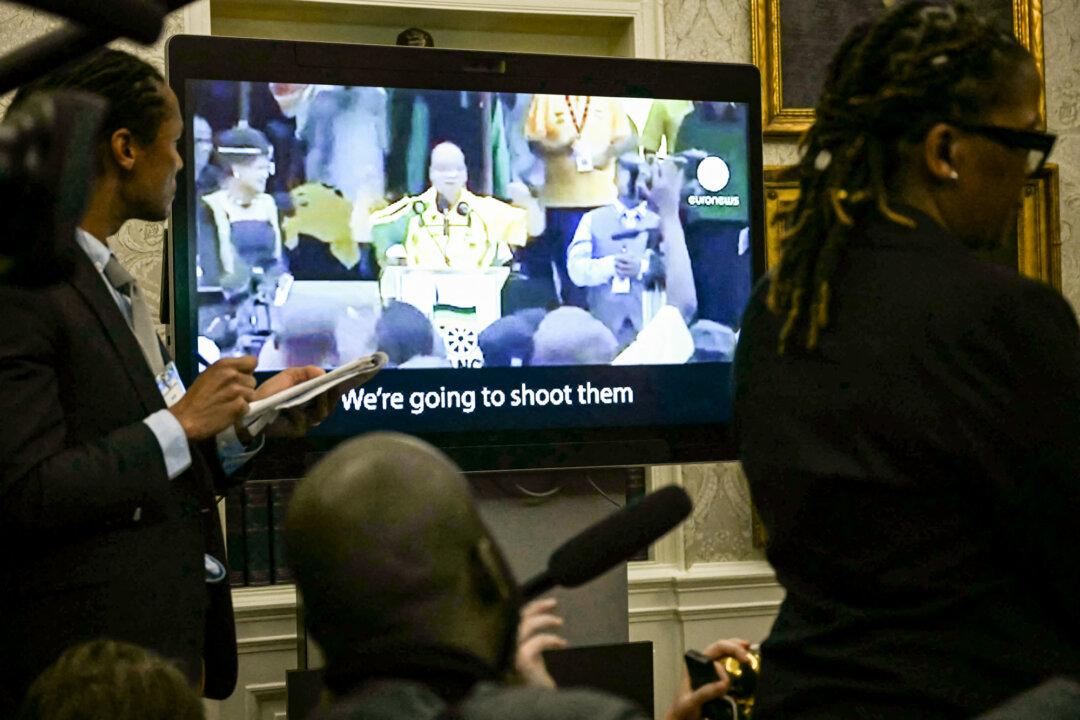 A video plays as South African President Cyril Ramaphosa meets with President Donald Trump in the Oval Office on May 21, 2025. The meeting occurred amid tensions over Washington’s resettlement of white Afrikaners, whom Trump has said are victims of genocide. (Jim Watson/AFP via Getty Images)