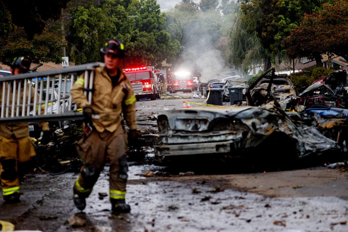 Firefighters work the site where a small plane crashed into a San Diego, California, on May 22, 2025. (Sandy Huffaker/AFP via Getty Images)