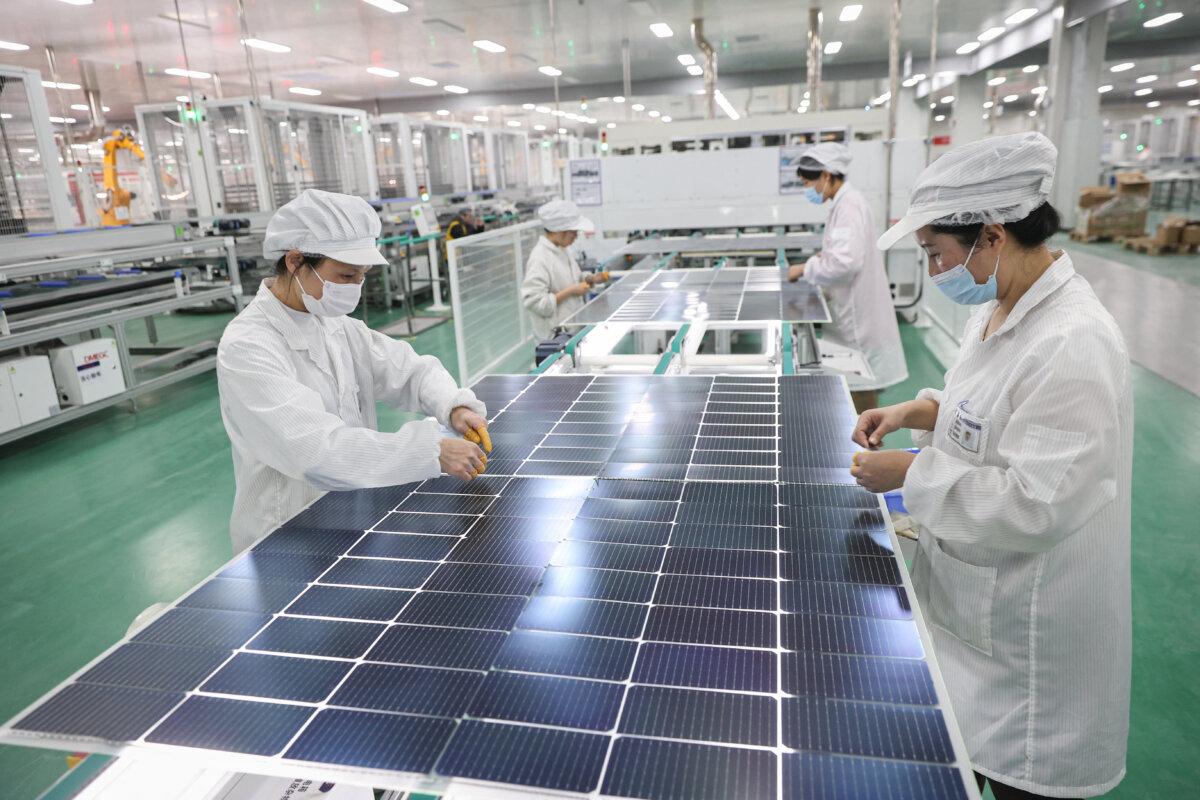 Employees work on solar modules made for export at a factory in Lianyungang, Jiangsu Province, China, on Jan. 4, 2024. (STR/AFP via Getty Images)