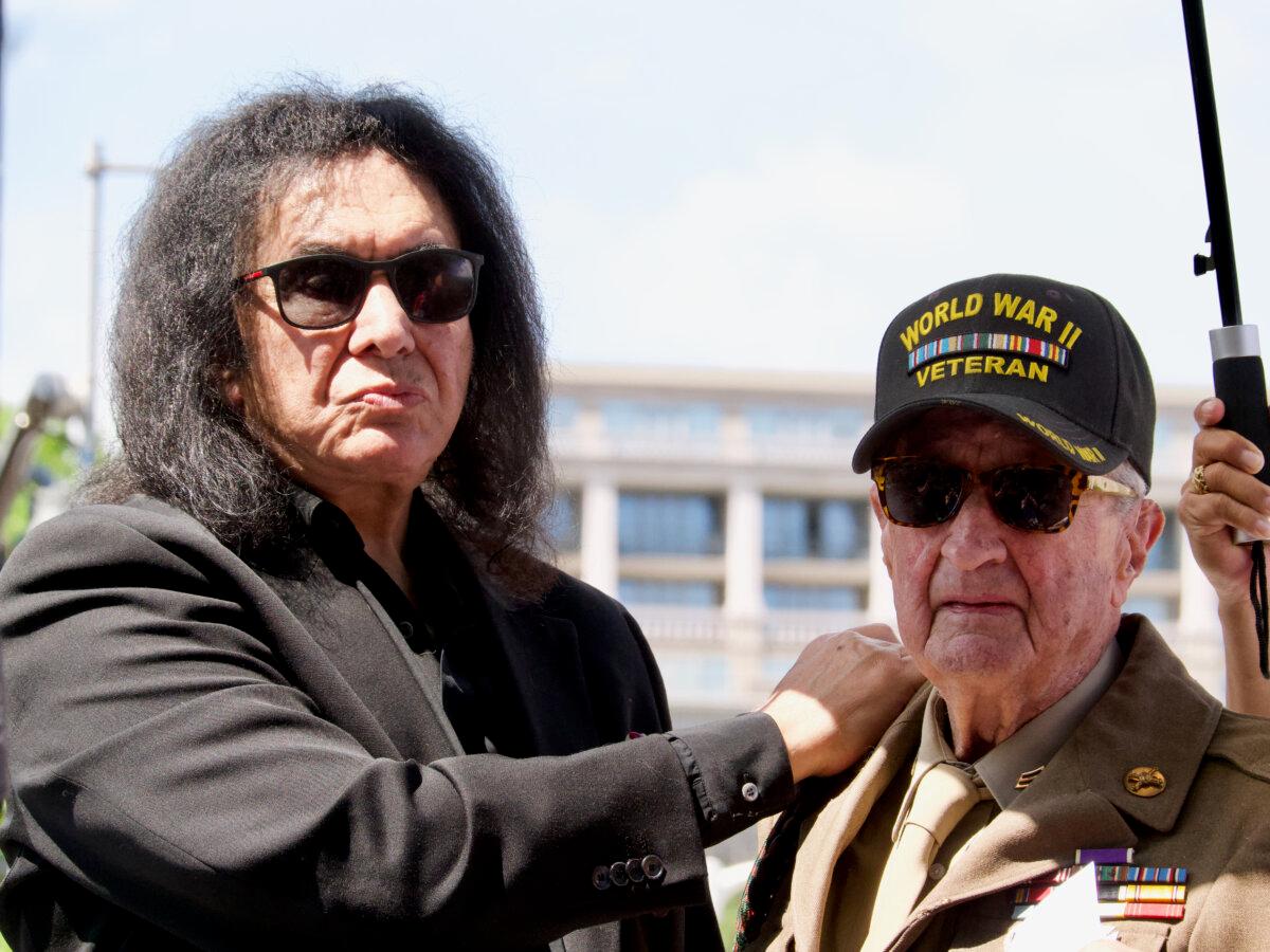 Gene Simmons (L) and Hal Urban, who helped liberate Simmons's mother from a concentration camp in 1945, on a float at the National Memorial Day Parade in Washington on May 26, 2025. (Travis Gillmore/The Epoch Times)