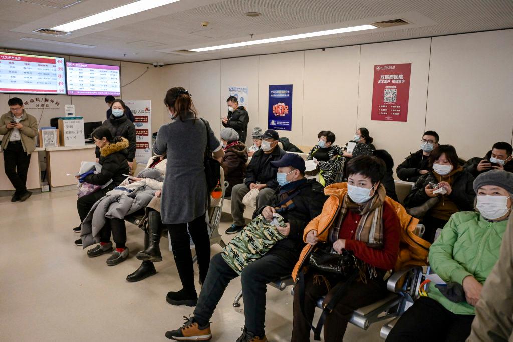 People wearing masks wait at an outpatient area of the respiratory department of a hospital in Beijing on Jan. 8, 2025. (Jade Gao/AFP via Getty Images)