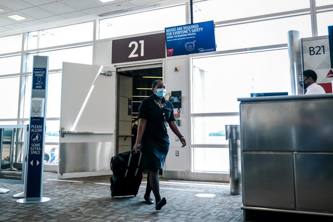 A flight attendant exits a Delta Air Lines flight at the Ronald Reagan Washington National Airport in Arlington, Va., on July 22, 2020. (Michael A. McCoy/Getty Images)
