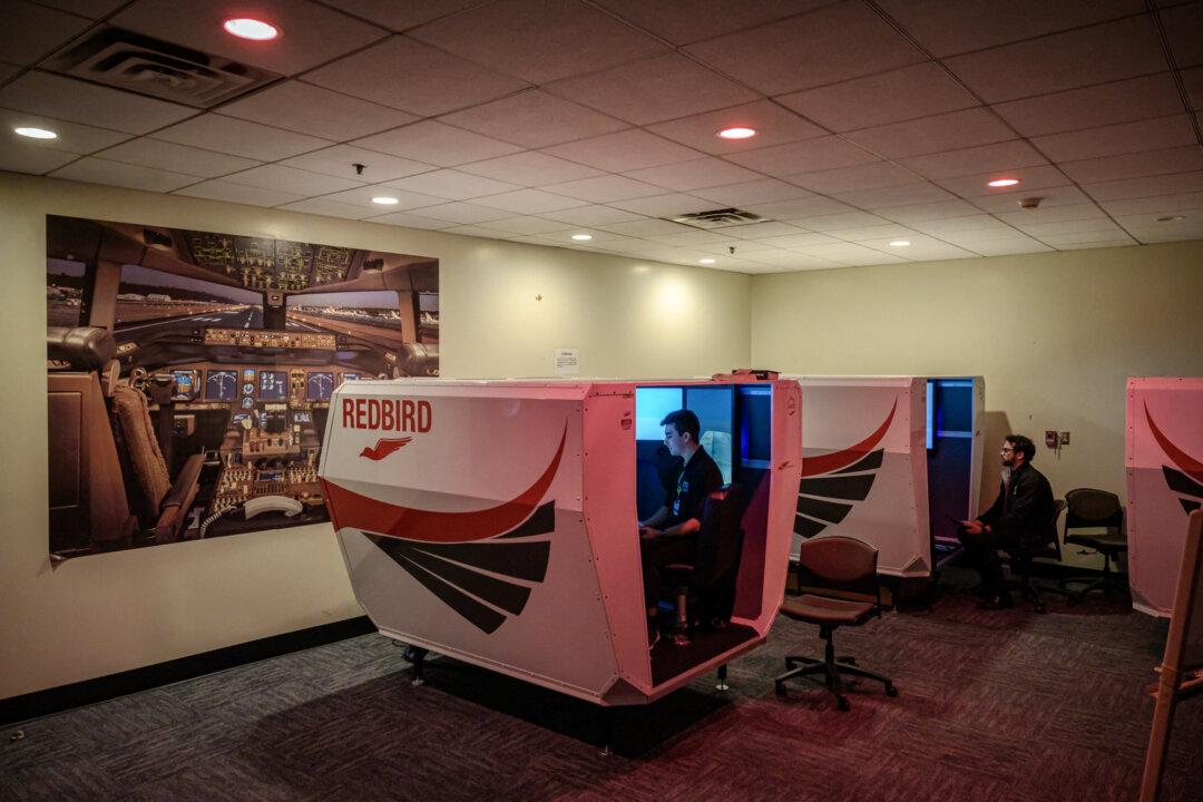 Instructors oversee student pilots during a training session in a flight simulator at Farmingdale State College in Farmingdale, N.Y., on Feb. 28, 2023. (Ed Jones/AFP via Getty Images)