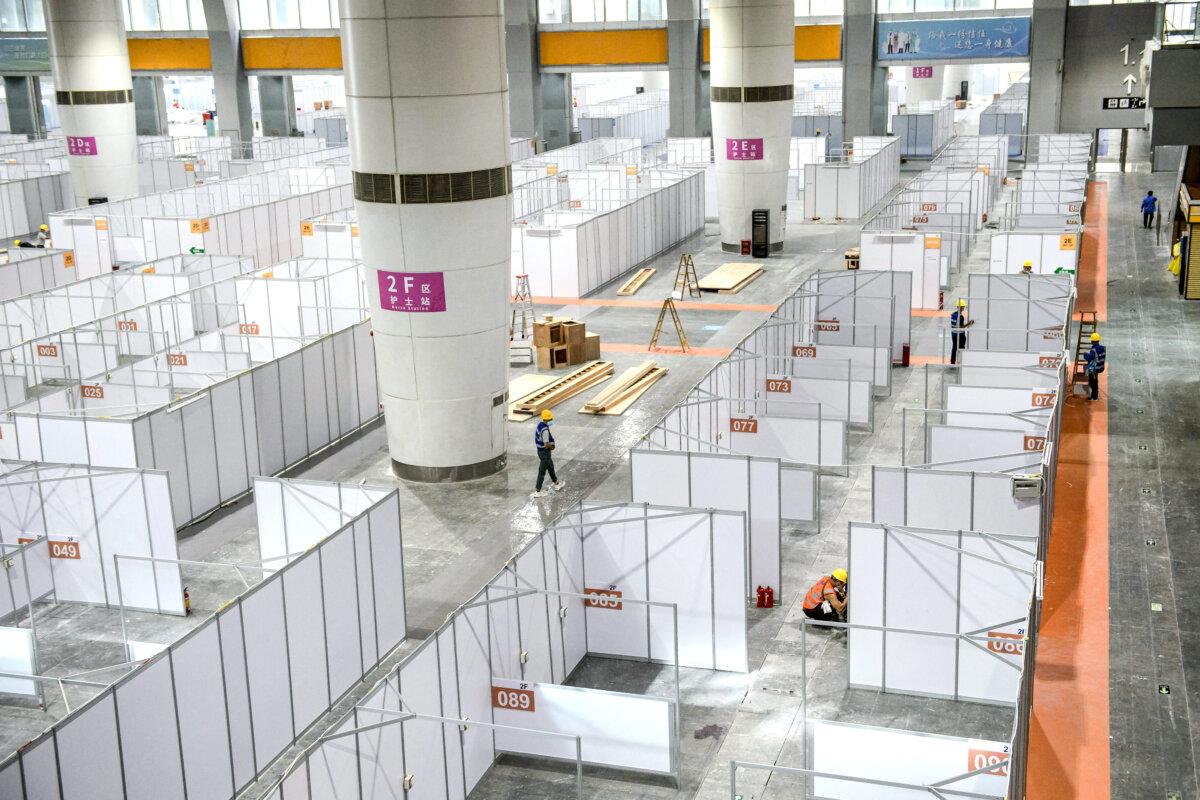 Employees work at a makeshift hospital that will be used for COVID-19 patients in Guangzhou, in China's eastern Guangdong Province, on April 11, 2022. (AFP via Getty Images)