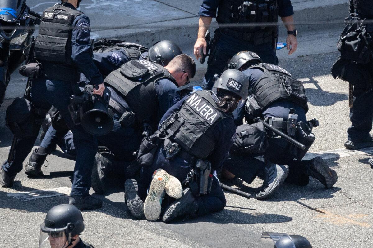 Police officers arrest a man in Los Angeles on June 8, 2025. (John Fredricks/The Epoch Times)