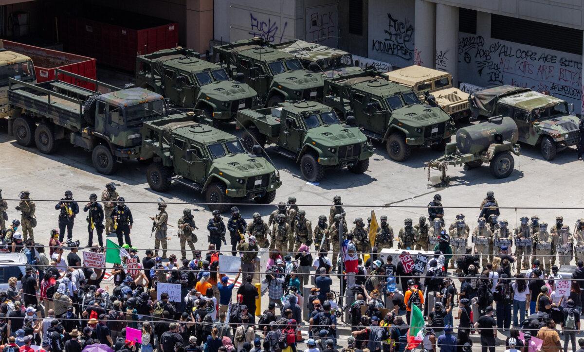 Protestors confront federal agents and California National Guardsmen in Los Angeles on June 8, 2025. (John Fredricks/The Epoch Times)
