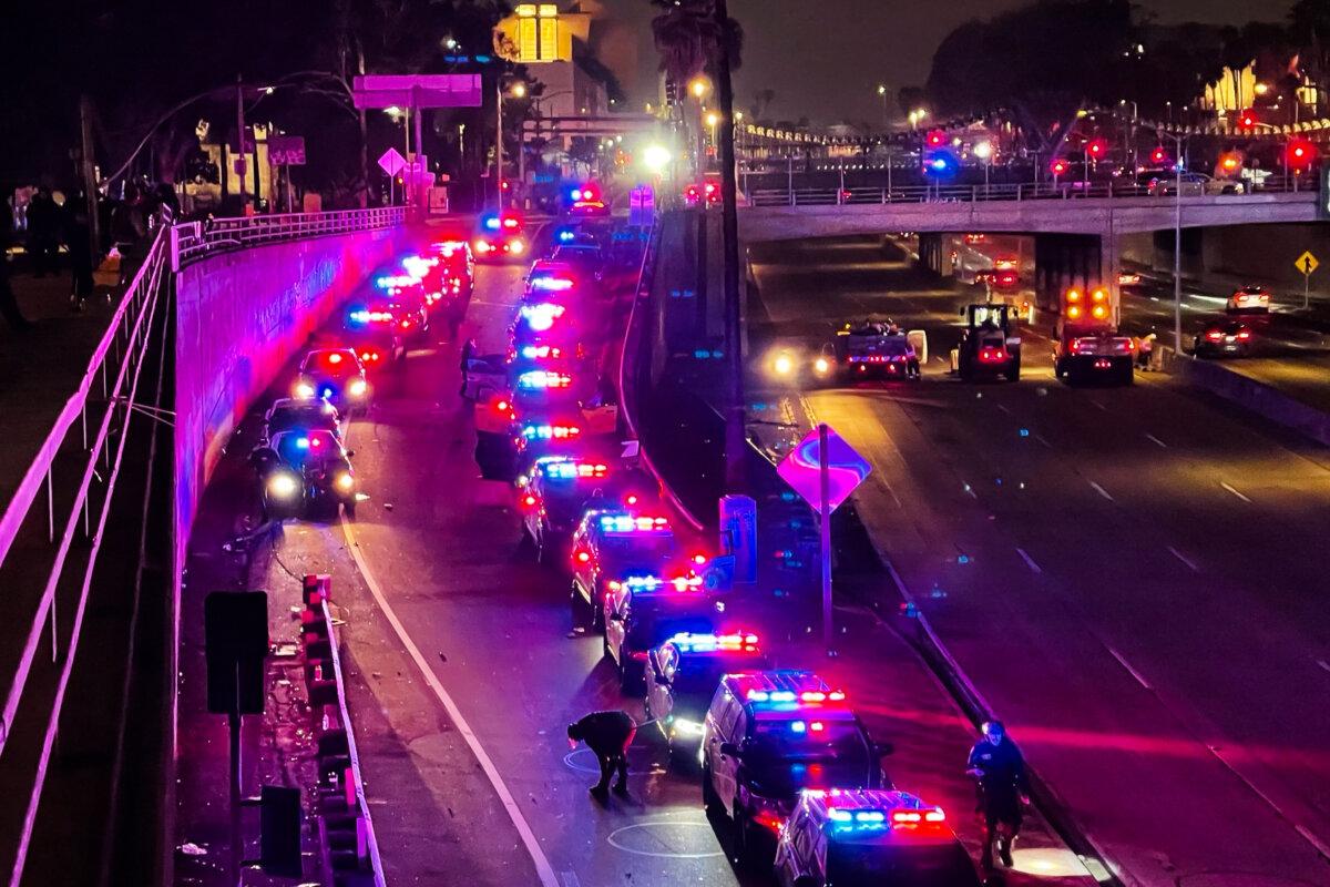 Police cars block the on-ramp to the 101 freeway in Los Angeles on June 8, 2025. (Melina Chan/The Epoch Times)