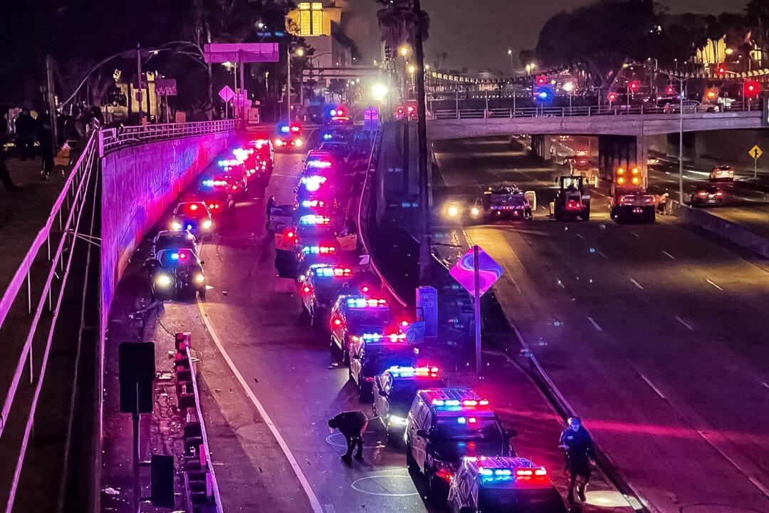 Police cars block the on-ramp to the 101 freeway in Los Angeles on June 8, 2025. (Melina Chan/The Epoch Times)