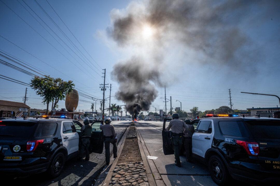 Law enforcement clashes with demonstrators during a protest following federal immigration operations, in the Compton neighborhood of Los Angeles on June 7, 2025. (Ringo Chiu/AFP via Getty Images)