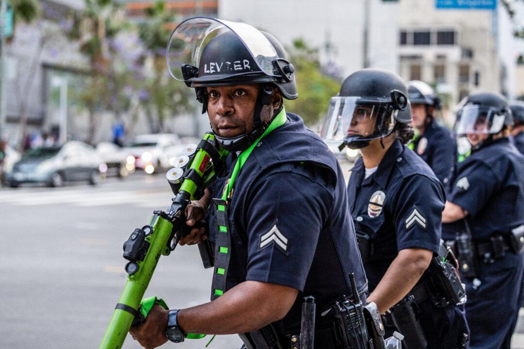 Law enforcement officers with less-lethal weapons take positions on the streets surrounding the federal building during a protest following federal immigration operations in Los Angeles on June 8, 2025. (Ringo Chiu/AFP via Getty Images)