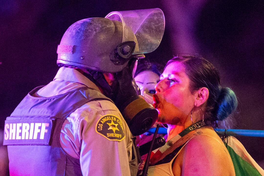 A protester faces off with a sheriff deputy amid clashes with law enforcement in the streets surrounding the federal building during a protest following federal immigration operations in Los Angeles on June 8, 2025. (Ringo Chiu/AFP via Getty Images)