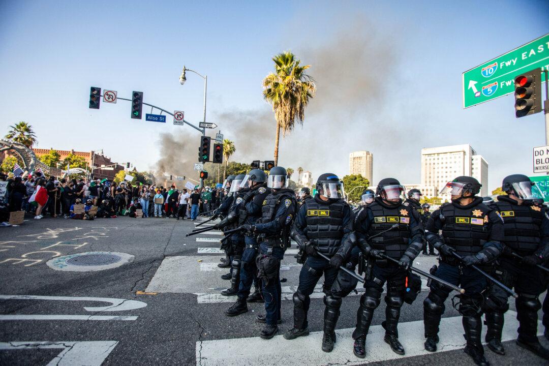 Protesters clash with law enforcement officers in the streets surrounding the federal building during a protest following federal immigration operations in Los Angeles on June 8, 2025. (Ringo Chiu/AFP via Getty Images)