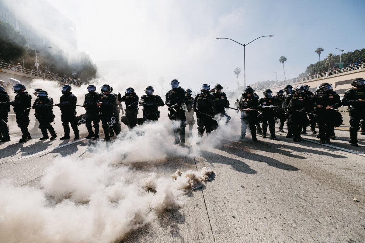Law enforcement officers in riot gear advance during protests in Los Angeles on June 8, 2025. (David Pashaee/Middle East Images/AFP via Getty Images)
